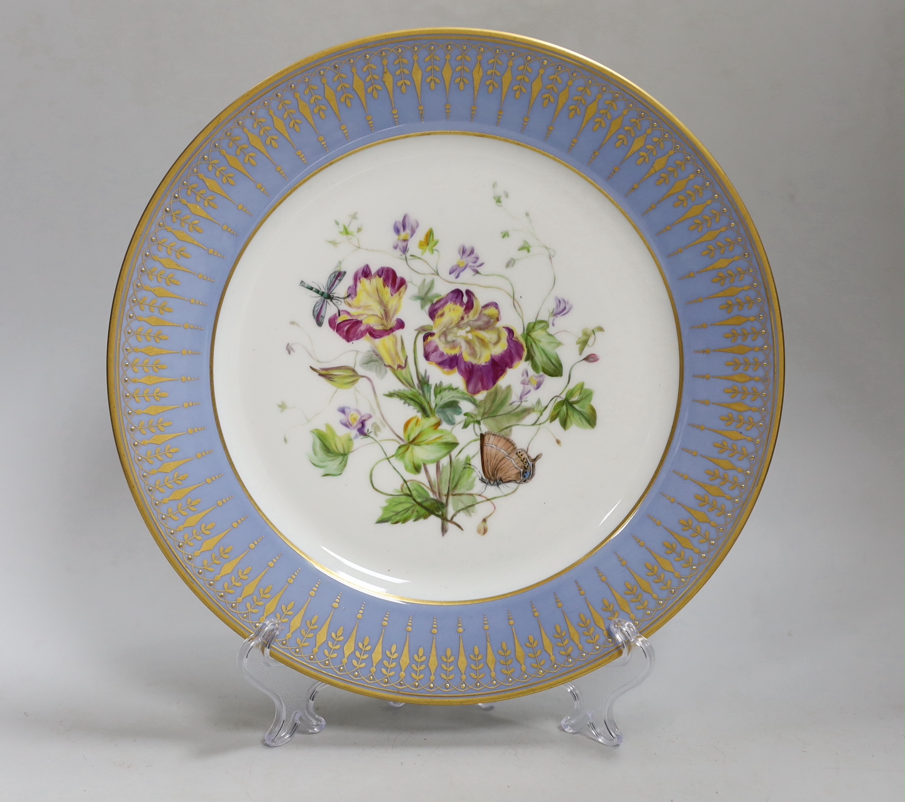 A 19th century Sevres plate painted flower under a blue and gilt border, marked S61 for 1861